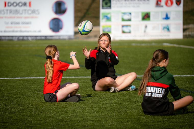 Players practising passing at camp